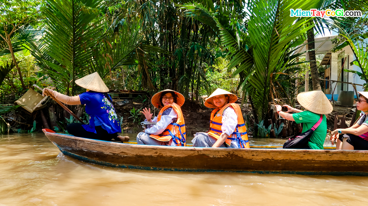 Tourists sit on a three-leaf boat to explore Con Thoi Son