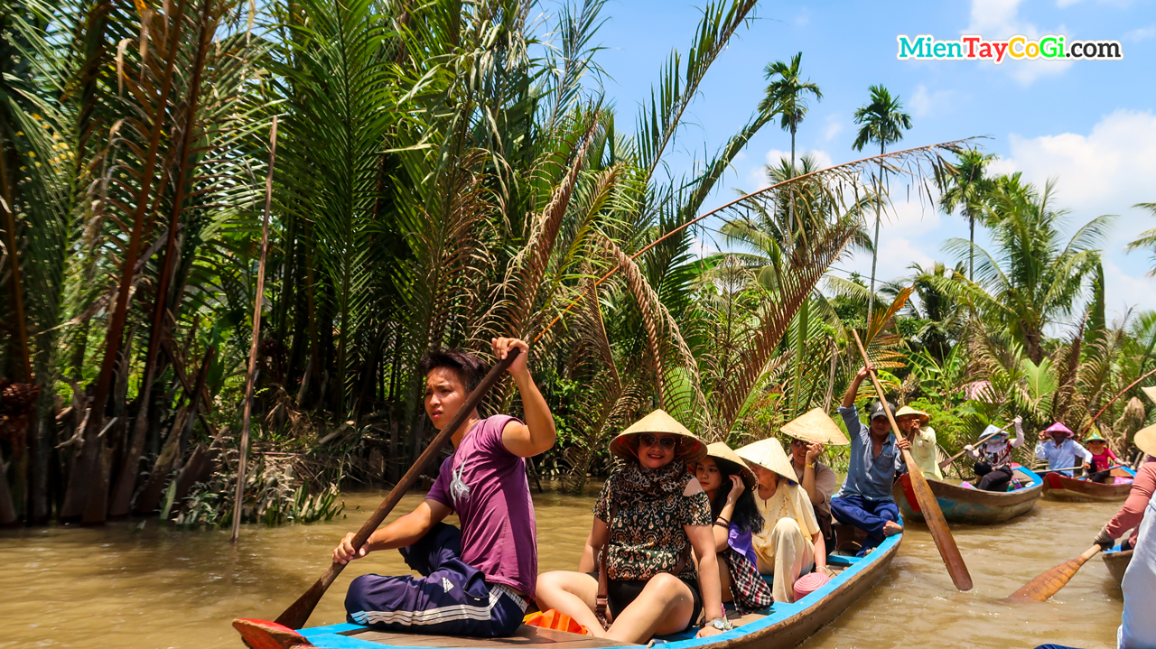 Tourists enjoy sitting in a canoe to explore the river