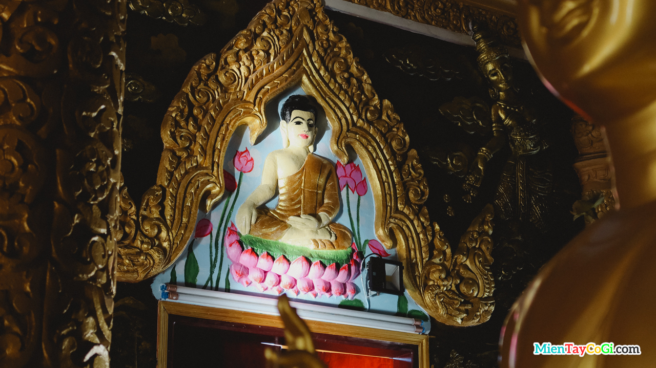 Nhiều tượng Phật nhỏ được điêu khắc trên tường ở chánh điện