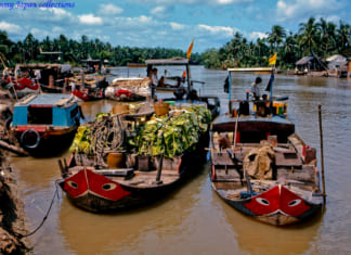 Tục cúng ghe tàu của người miền Tây Tàu thuyền neo đậu ở Bến Phà Chợ Gạo năm 1969 | Photo by Lance Cromwell